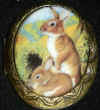 cameo_2NewRabbits_locketAntique.jpg (41774 bytes)